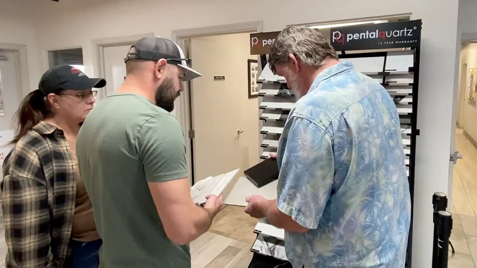 A Superior team member showing quartz samples to customers in the showroom